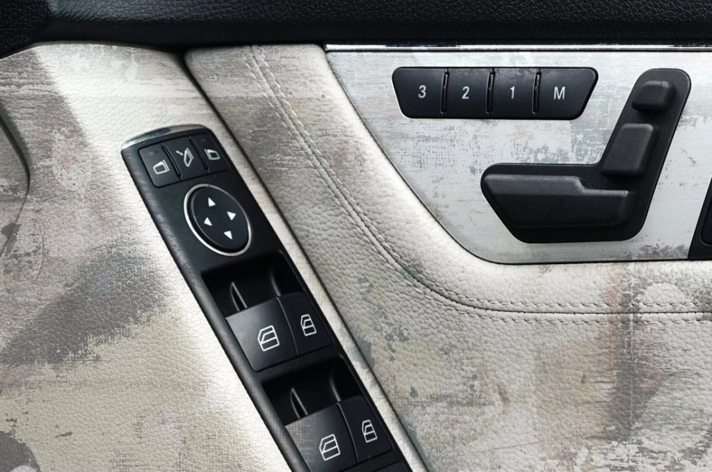 White leather door panel heavily soiled before cleaning