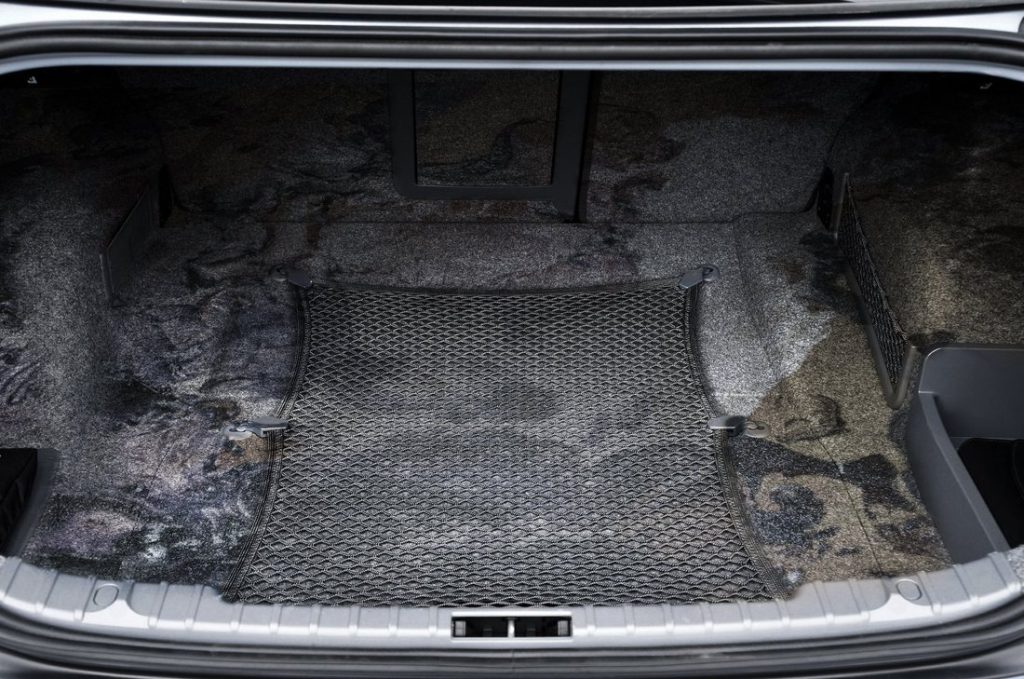 Car trunk carpet stained and dirty before cleaning