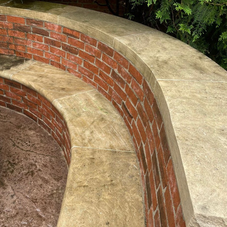Brick retaining wall and stamped concrete patio after cleaning
