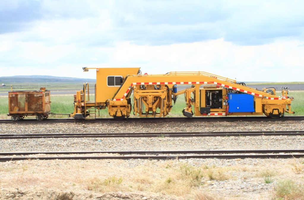 Yellow rail maintenance machine on track